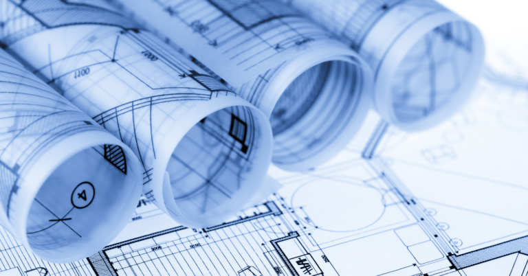 Multiple blueprints rolled up on the table