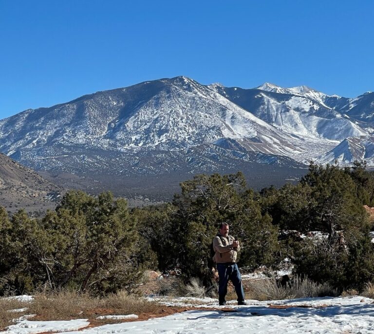 A person in a wheelchair using a computer to design a blueprint